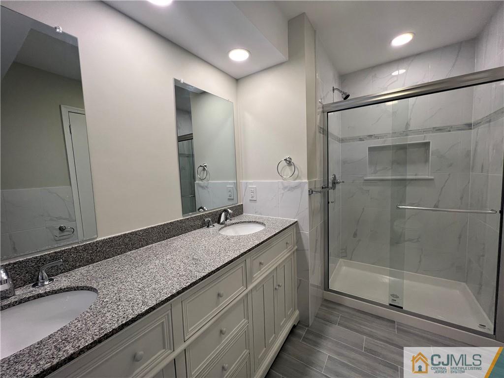 204 Maplecrest Road Edison, NJ 08820 - Photo 2 of 9 a bathroom with a granite countertop sink mirror and double