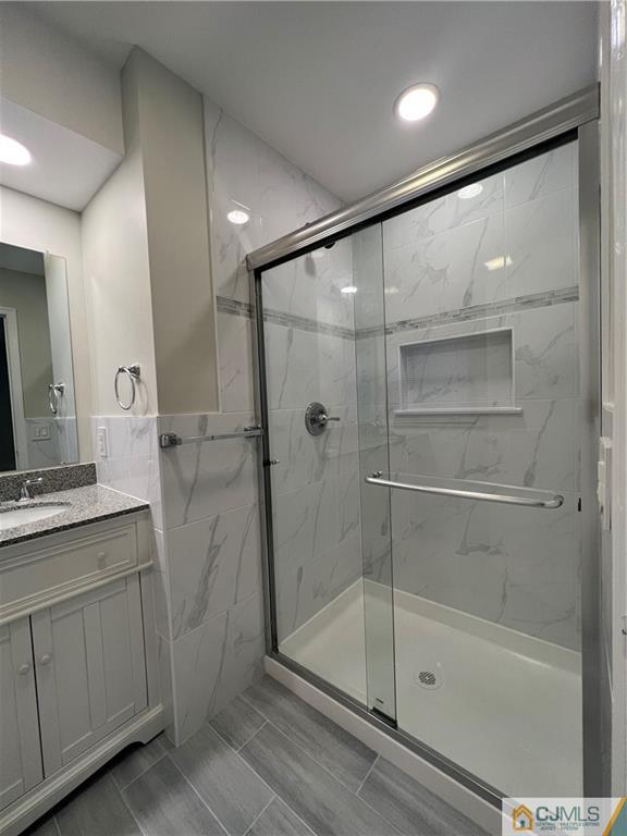 204 Maplecrest Road Edison, NJ 08820 - Photo 3 of 9 a bathroom with a shower a mirror and a sink