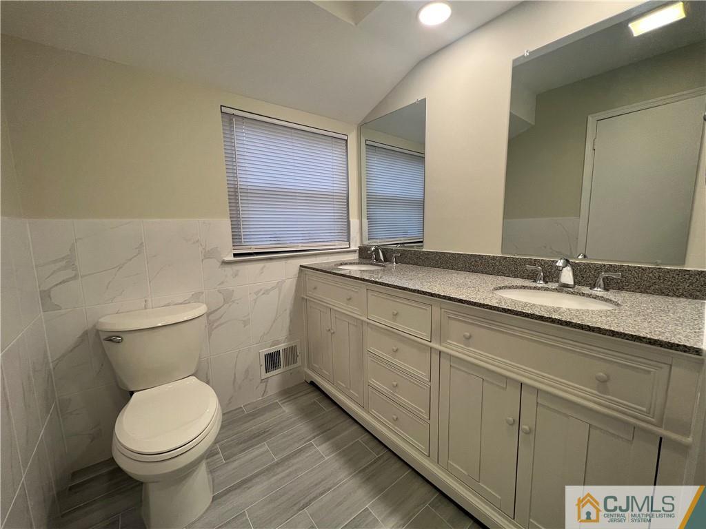 204 Maplecrest Road Edison, NJ 08820 - Photo 4 of 9 a bathroom with a granite countertop toilet sink and mirror