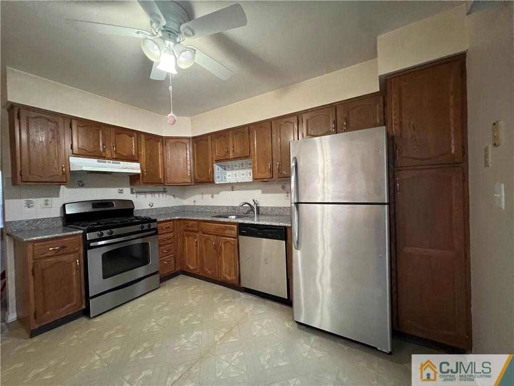 204 Maplecrest Road Edison, NJ 08820 - Photo 5 of 9 a kitchen with stainless steel appliances granite countertop a refrigerator stove a sink and dishwasher