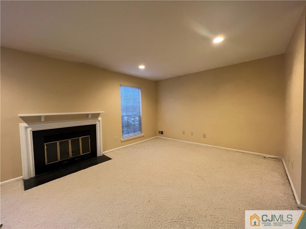 204 Maplecrest Road Edison, NJ 08820 - Photo 6 of 9 a view of an empty room with a fireplace