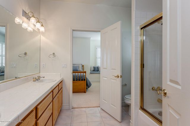 a bathroom with a tub sink and mirror