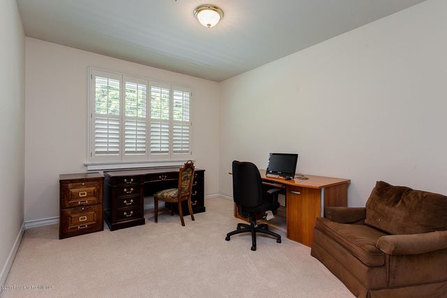 a livingroom with workspace and a window