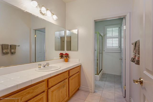 a bathroom with a double vanity sink and mirror
