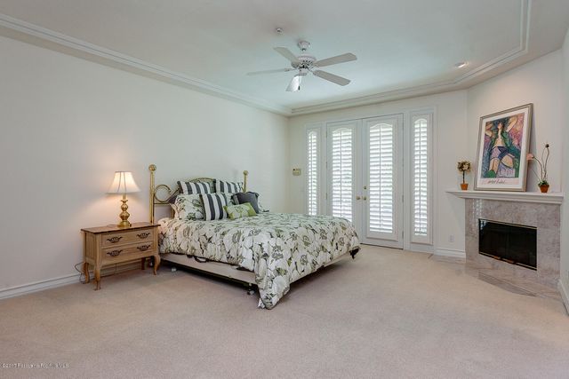 a bedroom with a bed and a fireplace