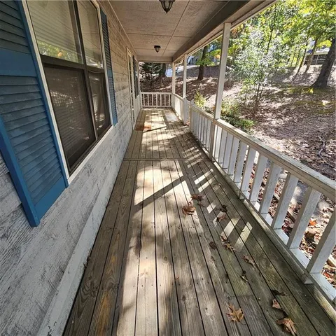 a view of a porch with wooden floor