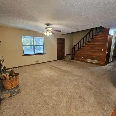 a view of a room with lots of wooden furniture