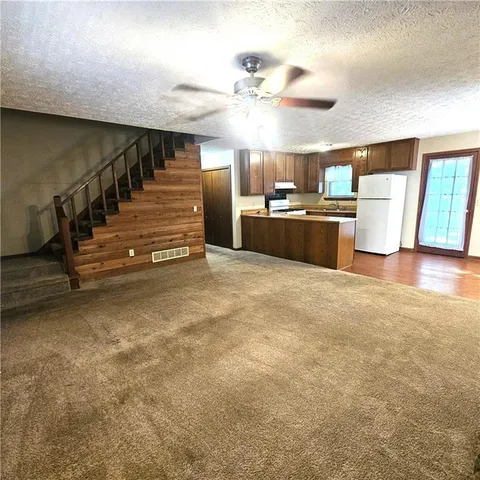a kitchen with wooden cabinets and white stainless steel appliances
