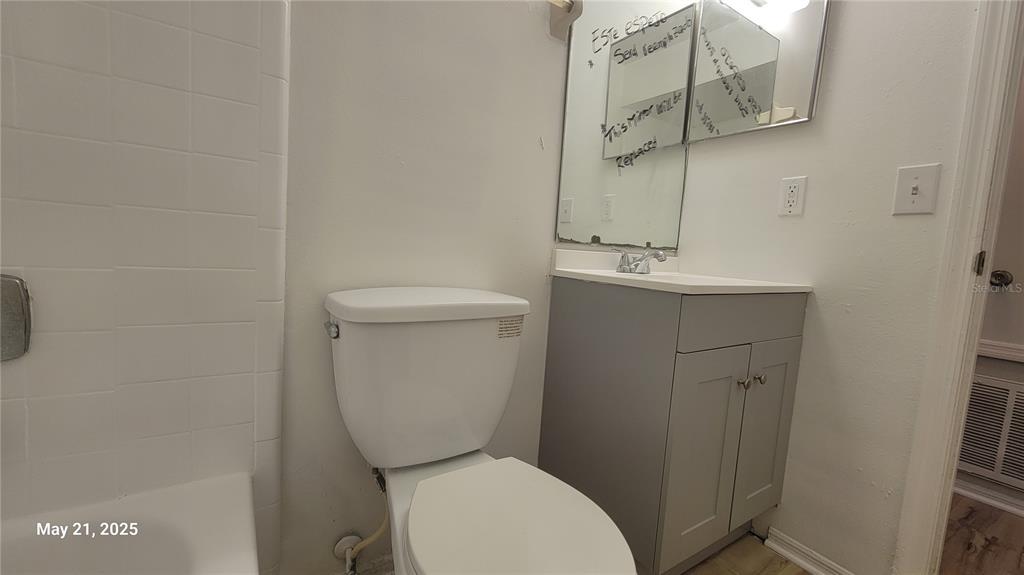 4136 Pershing Pointe Place, Unit 5 Orlando, FL 32822 - Photo 11 of 21 a bathroom with a toilet sink and mirror
