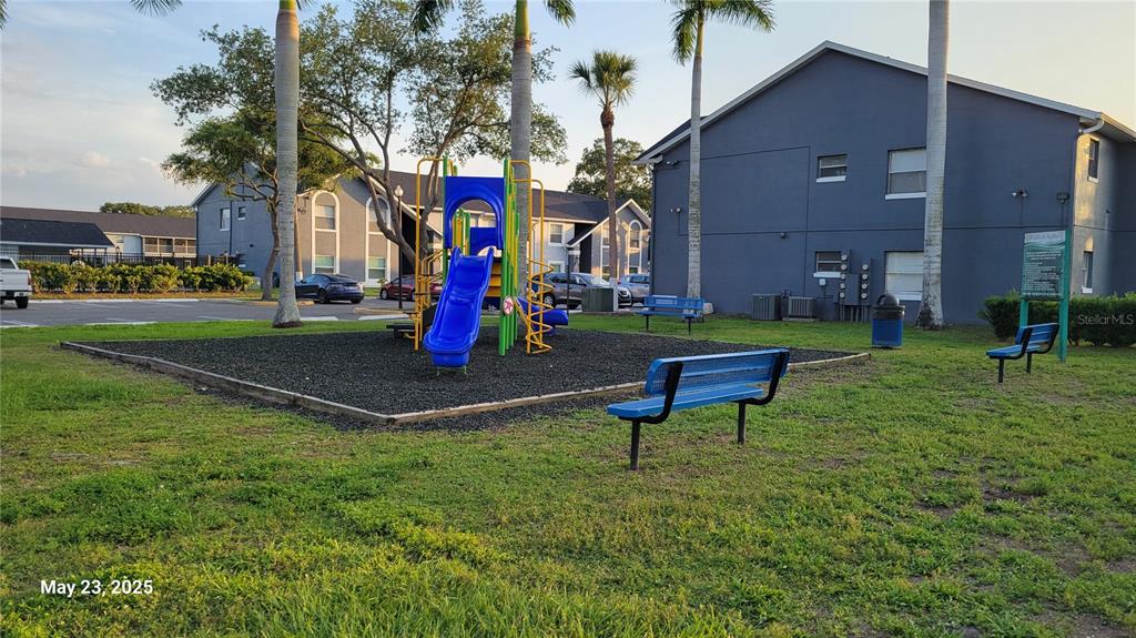 4136 Pershing Pointe Place, Unit 5 Orlando, FL 32822 - Photo 16 of 21 a view of a park with slide and a bench