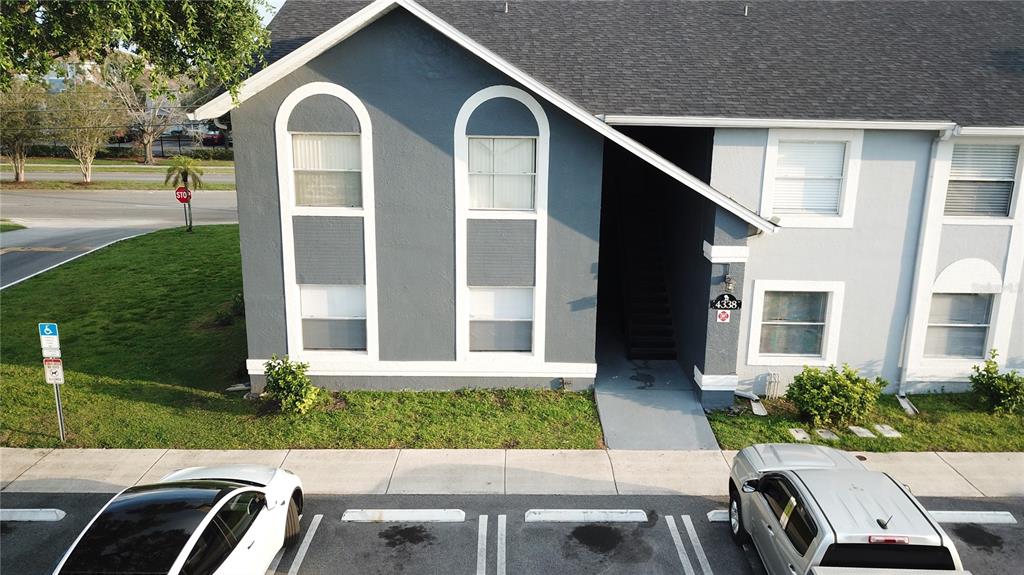 4136 Pershing Pointe Place, Unit 5 Orlando, FL 32822 - Photo 20 of 21 a front view of house with a yard