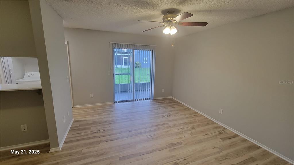 4136 Pershing Pointe Place, Unit 5 Orlando, FL 32822 - Photo 6 of 21 wooden floor in an empty room with a window