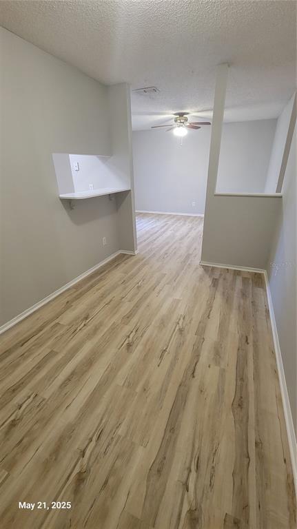 4136 Pershing Pointe Place, Unit 5 Orlando, FL 32822 - Photo 7 of 21 a view of empty room with wooden floor