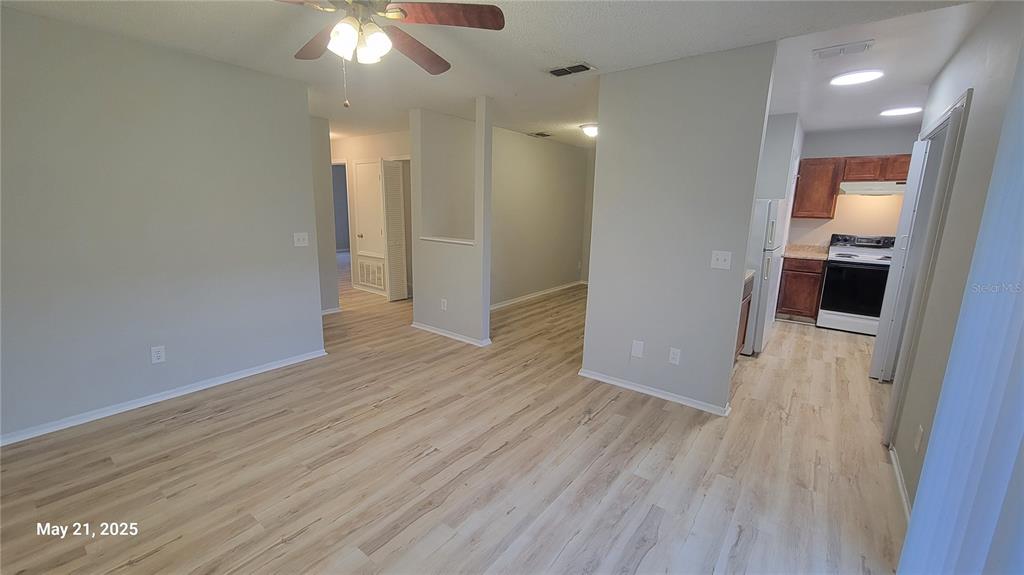 4136 Pershing Pointe Place, Unit 5 Orlando, FL 32822 - Photo 8 of 21 a view of livingroom with hardwood floor and a ceiling fan