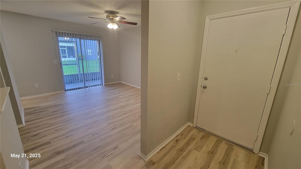 4136 Pershing Pointe Place, Unit 5 Orlando, FL 32822 - Photo 9 of 21 a view of hallway with wooden floor