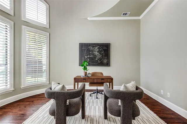 a view of a workspace with furniture and a window