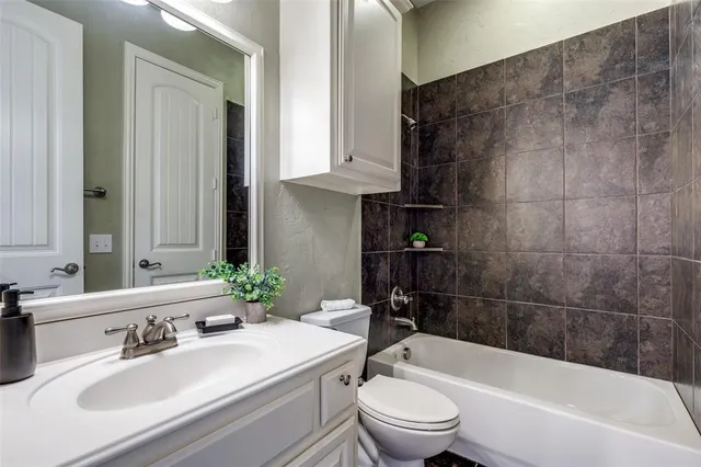 a bathroom with a sink a toilet and bathtub
