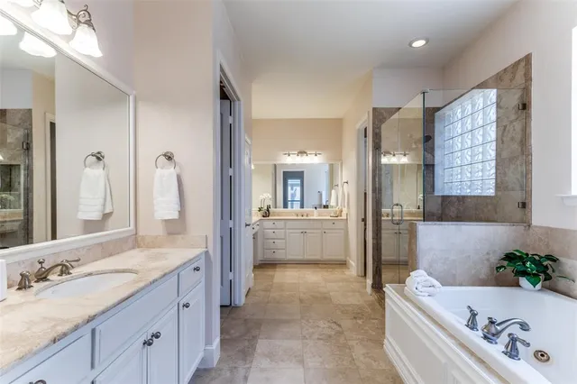 a bathroom with a tub sink and mirror