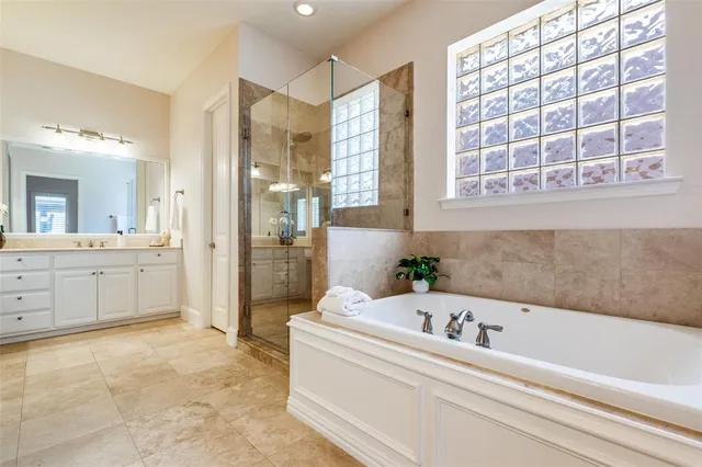 a bathroom with a bathtub and a shower
