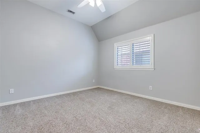 a view of a big room with windows and a kitchen