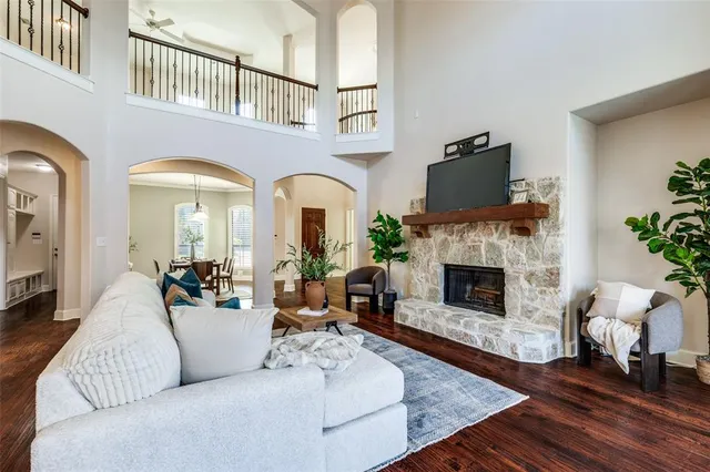 a living room with furniture fireplace and potted plants