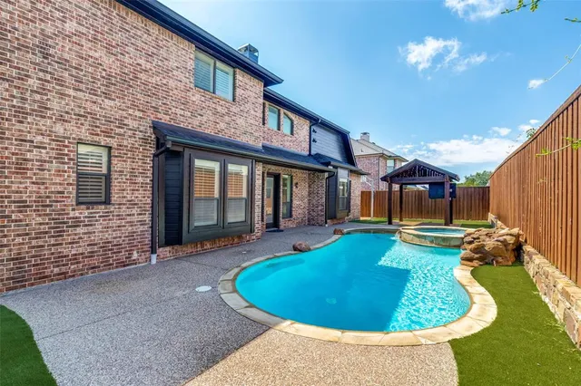 a view of a house with swimming pool and porch
