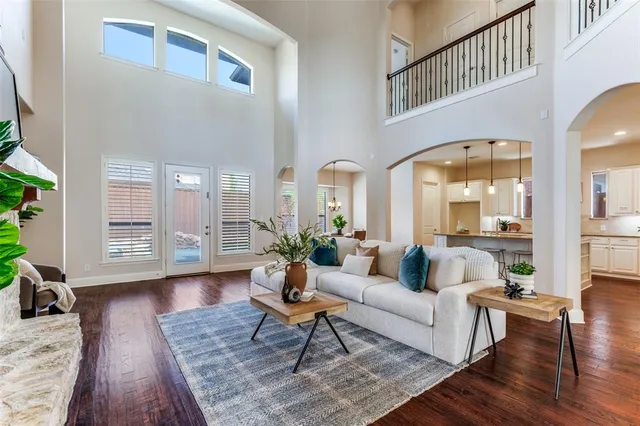 a living room with furniture fireplace and wooden floor