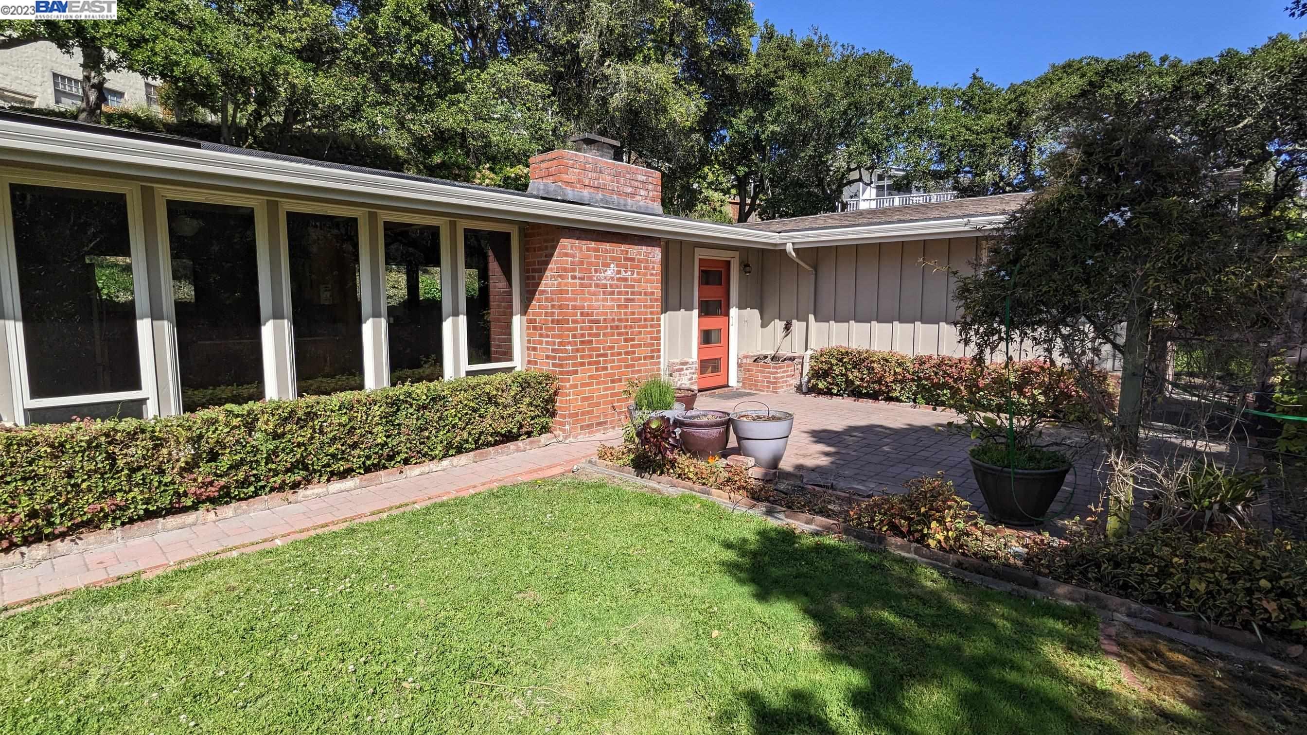 a view of a house with backyard sitting area and garden