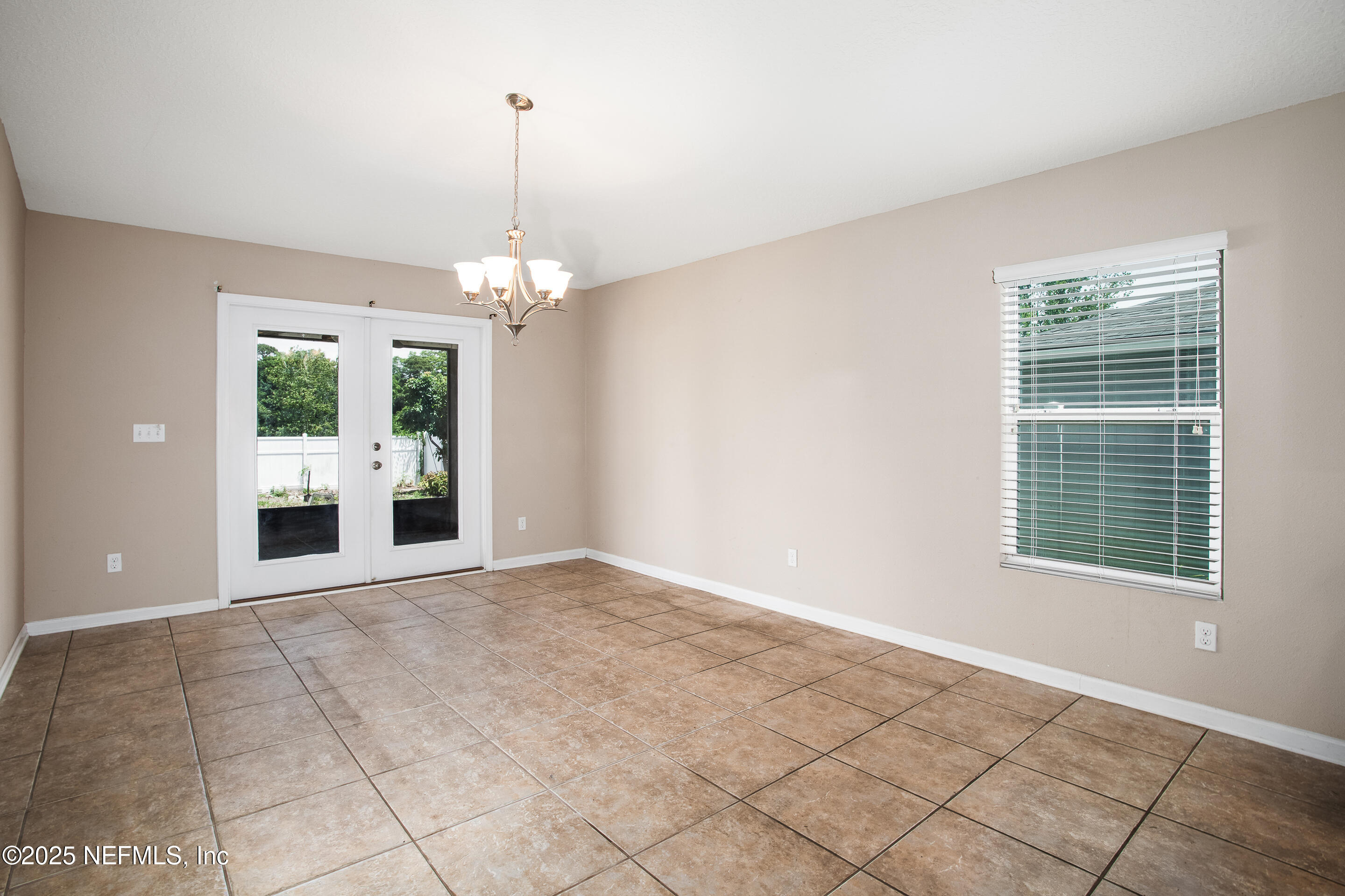 3880 Great Falls Loop Middleburg, FL 32068 - Photo 6 of 21 a view of a room with an empty space and chandelier