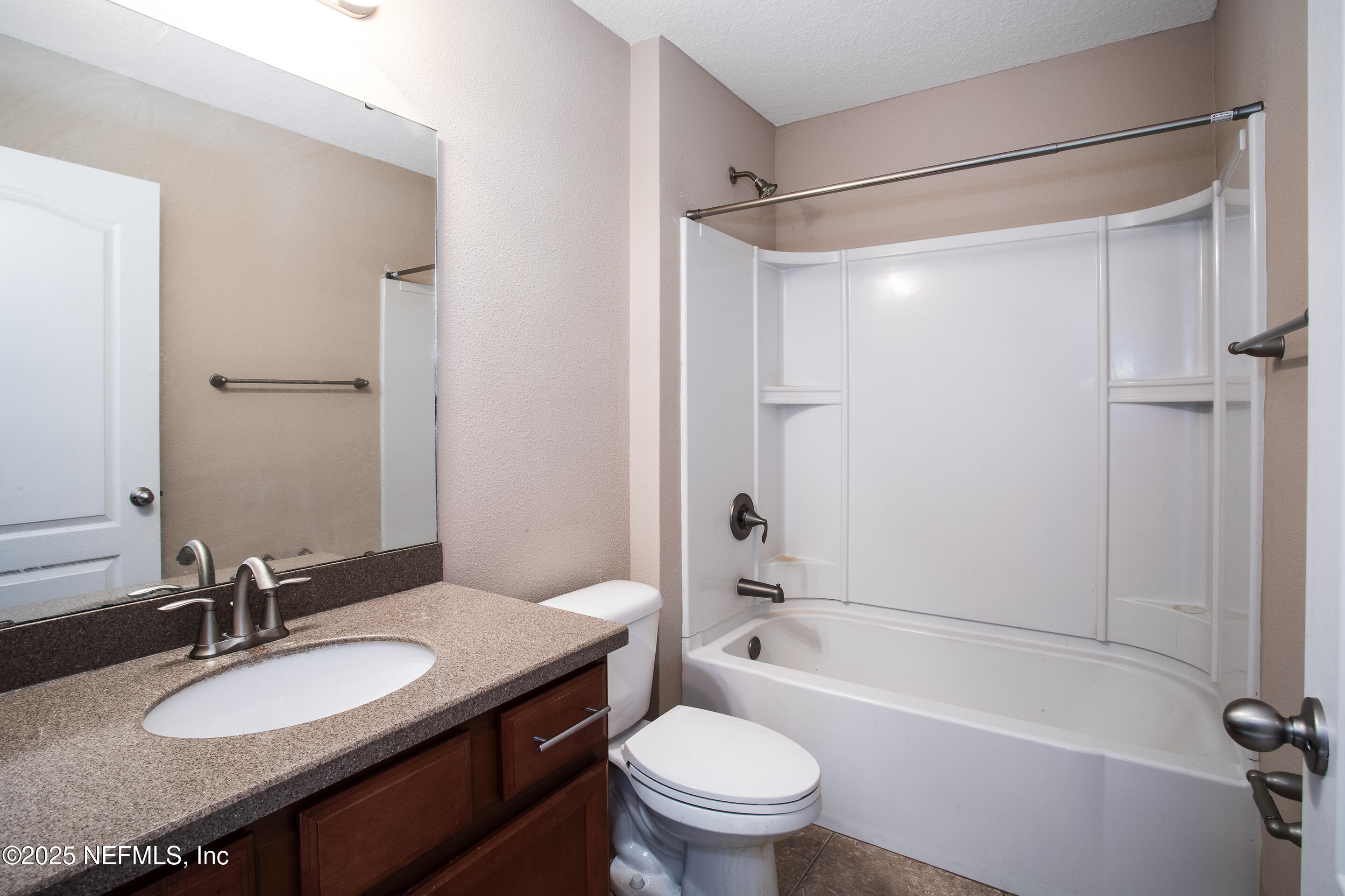 3880 Great Falls Loop Middleburg, FL 32068 - Photo 9 of 21 a bathroom with a granite countertop sink toilet mirror and shower