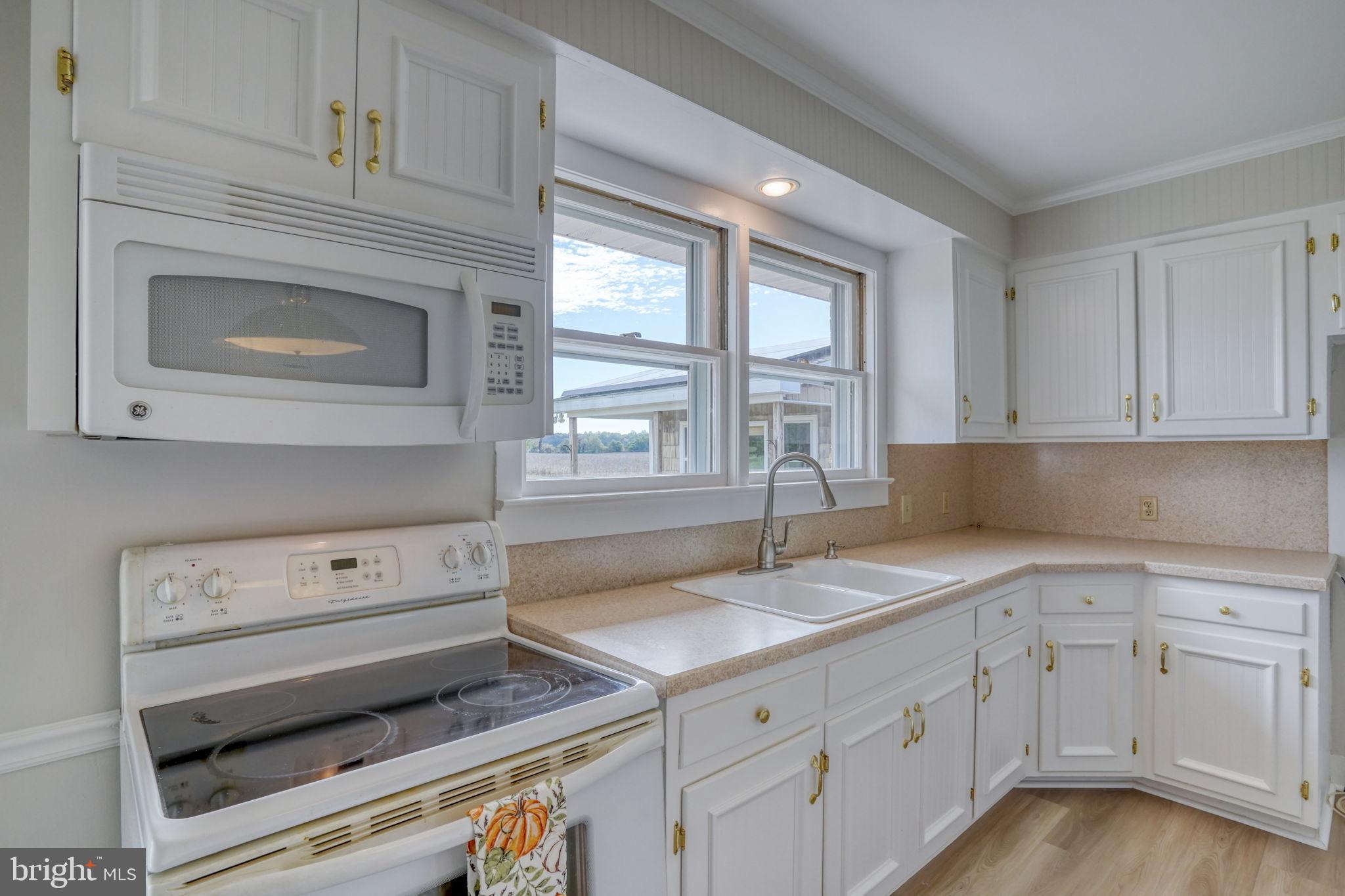 2968 Deep Grass Lane Houston, DE 19954 - Photo 21 of 41 a kitchen with granite countertop white cabinets appliances and a sink