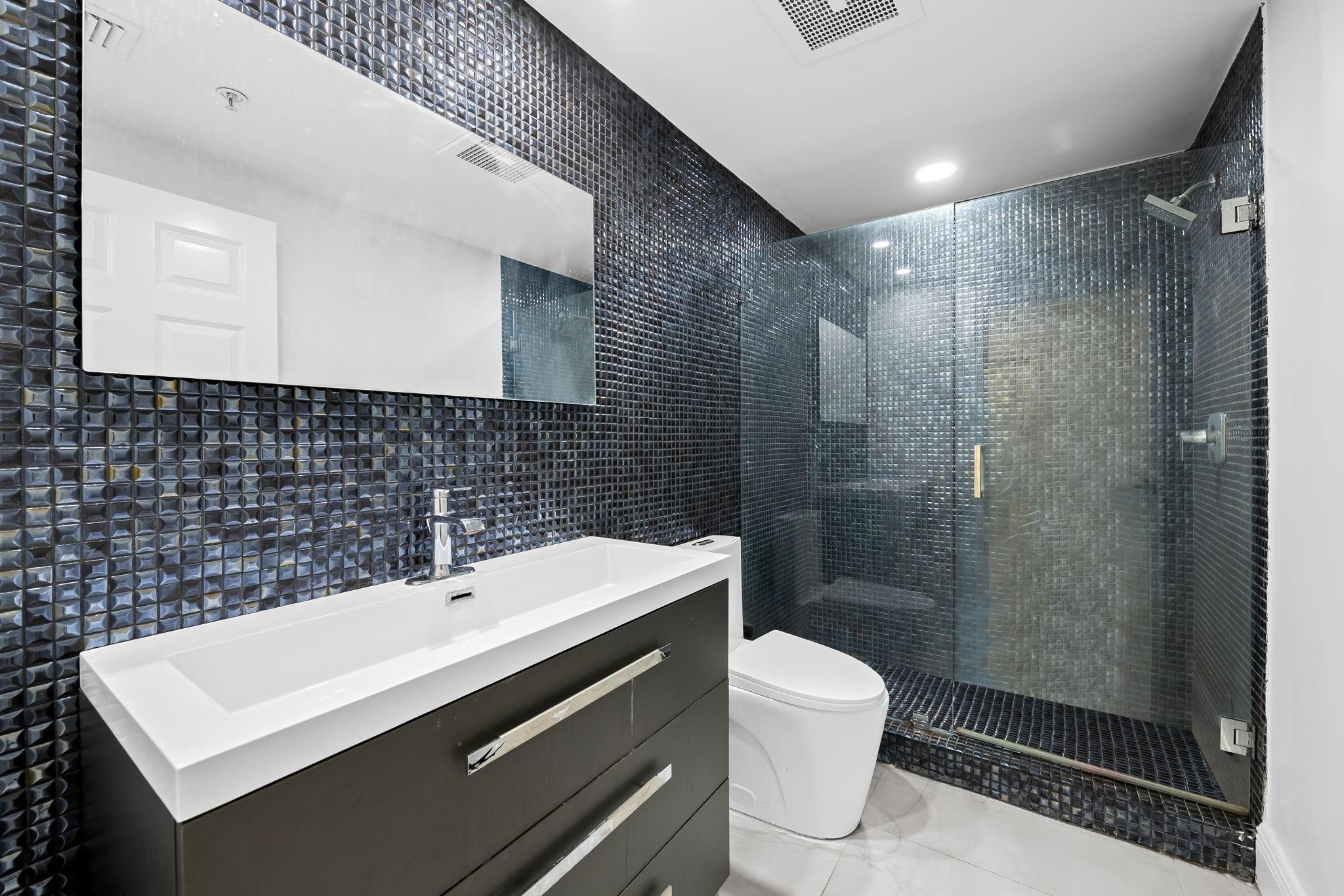 456 East Boca Raton Road Boca Raton, FL 33432 - Photo 16 of 33 a bathroom with a sink a toilet and shower