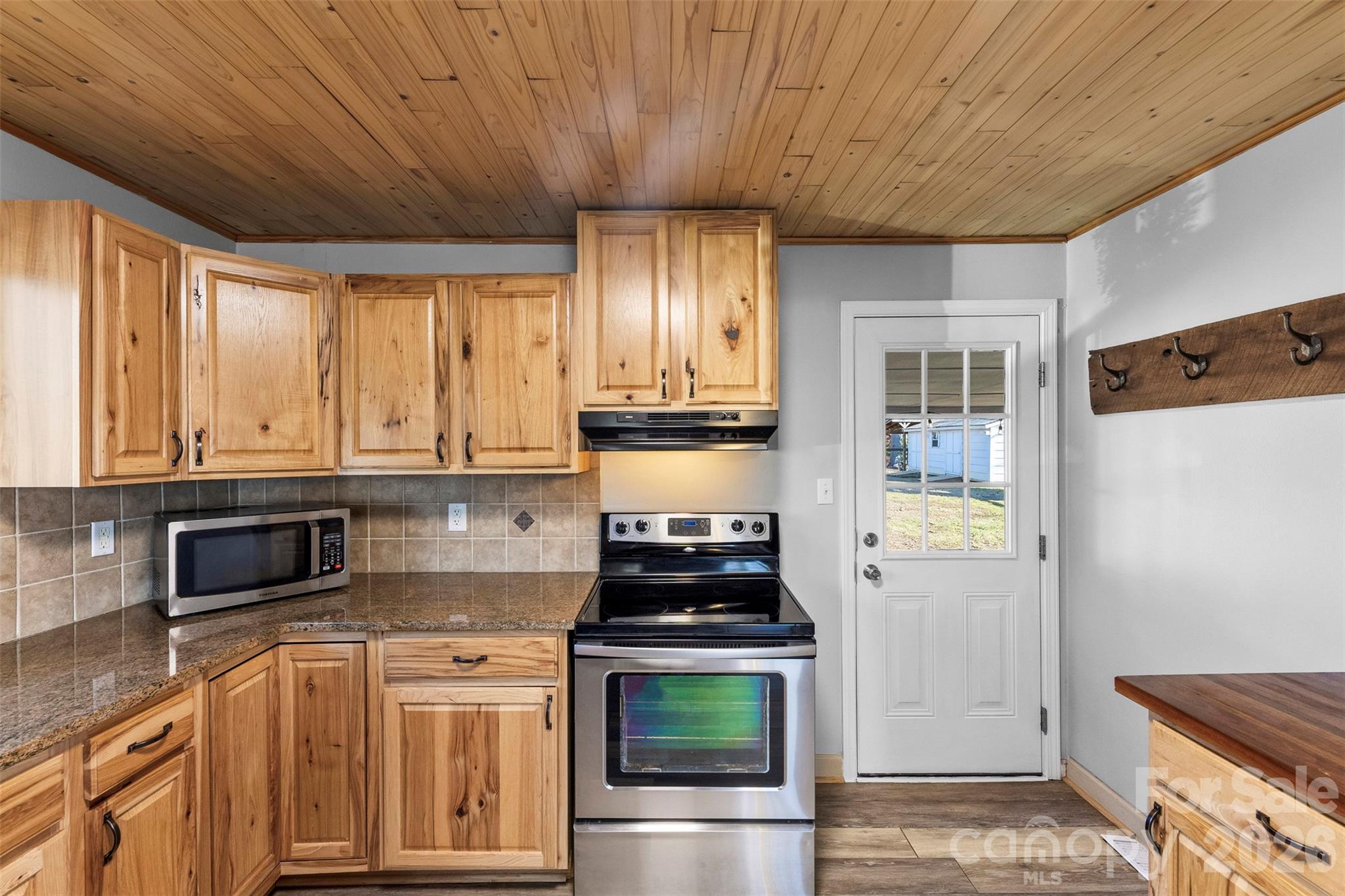 652 Dallas Spencer Mountain Road Dallas, NC 28034 - Photo 9 of 26 a kitchen with stainless steel appliances granite countertop a stove a sink and a refrigerator