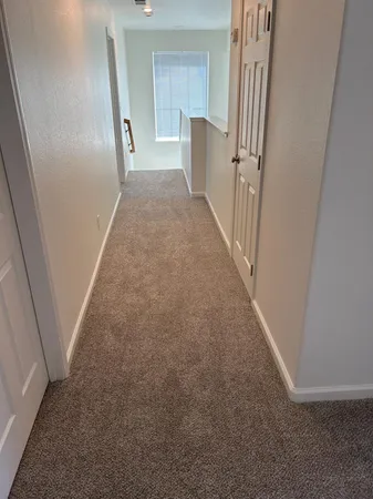 a view of a hallway with staircase