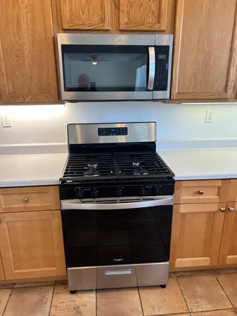a stove top oven sitting inside of a kitchen