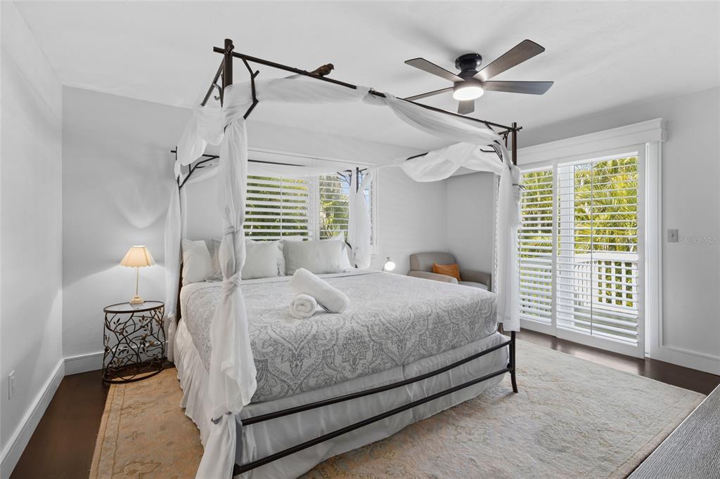 315 Spring Avenue Anna Maria, FL 34216 - Photo 26 of 63 a bedroom with a bed and a chandelier