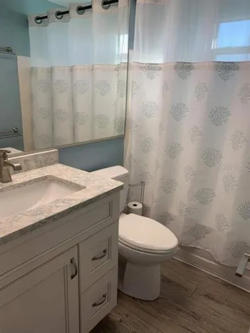 a bathroom with a toilet a sink and shower