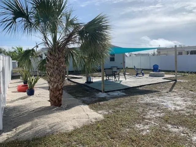 a row of palm trees and a fire pit