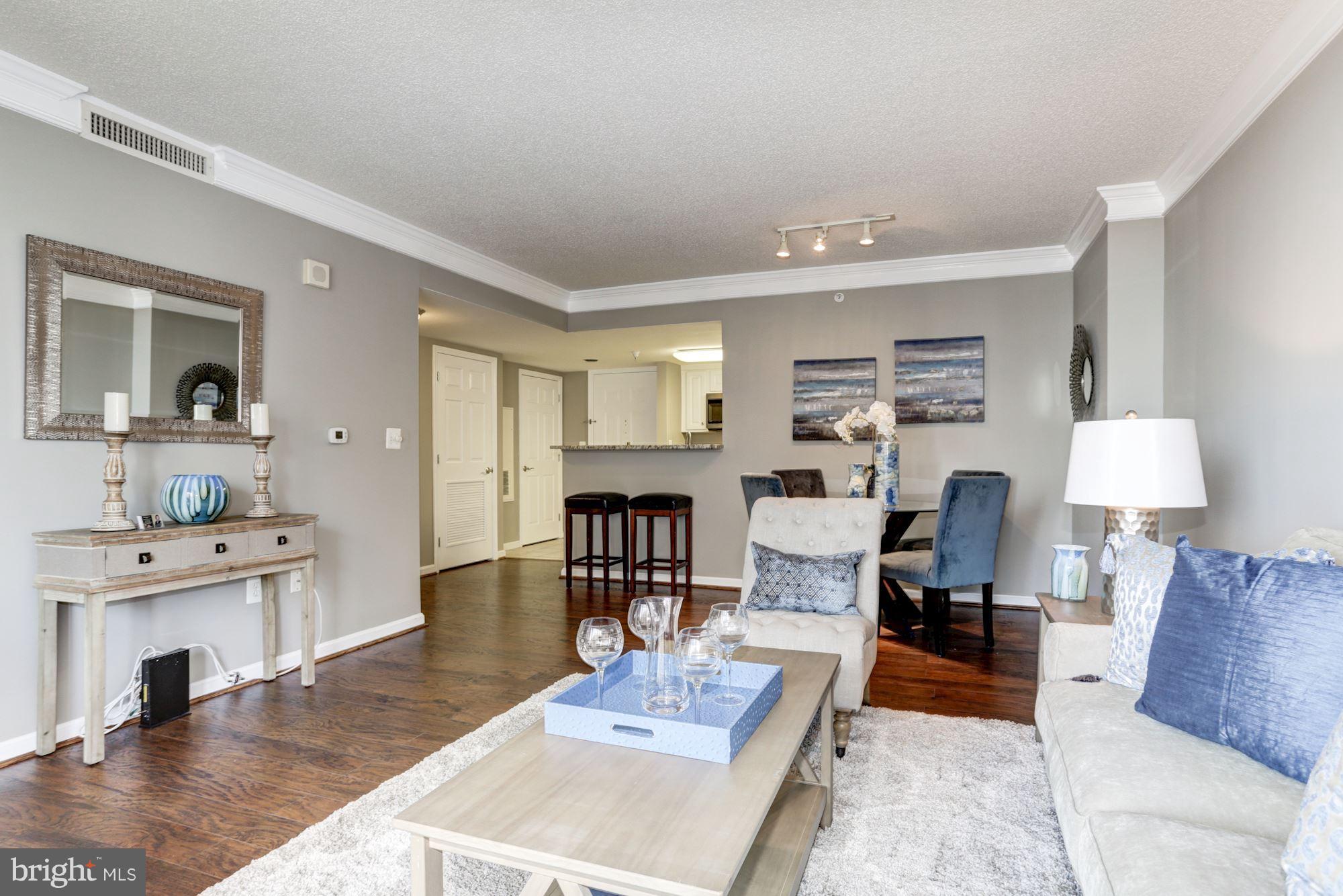 11710 Old Georgetown Road, Unit 1127 North Bethesda, MD 20852 - Photo 11 of 30 a living room with furniture and a wooden floor