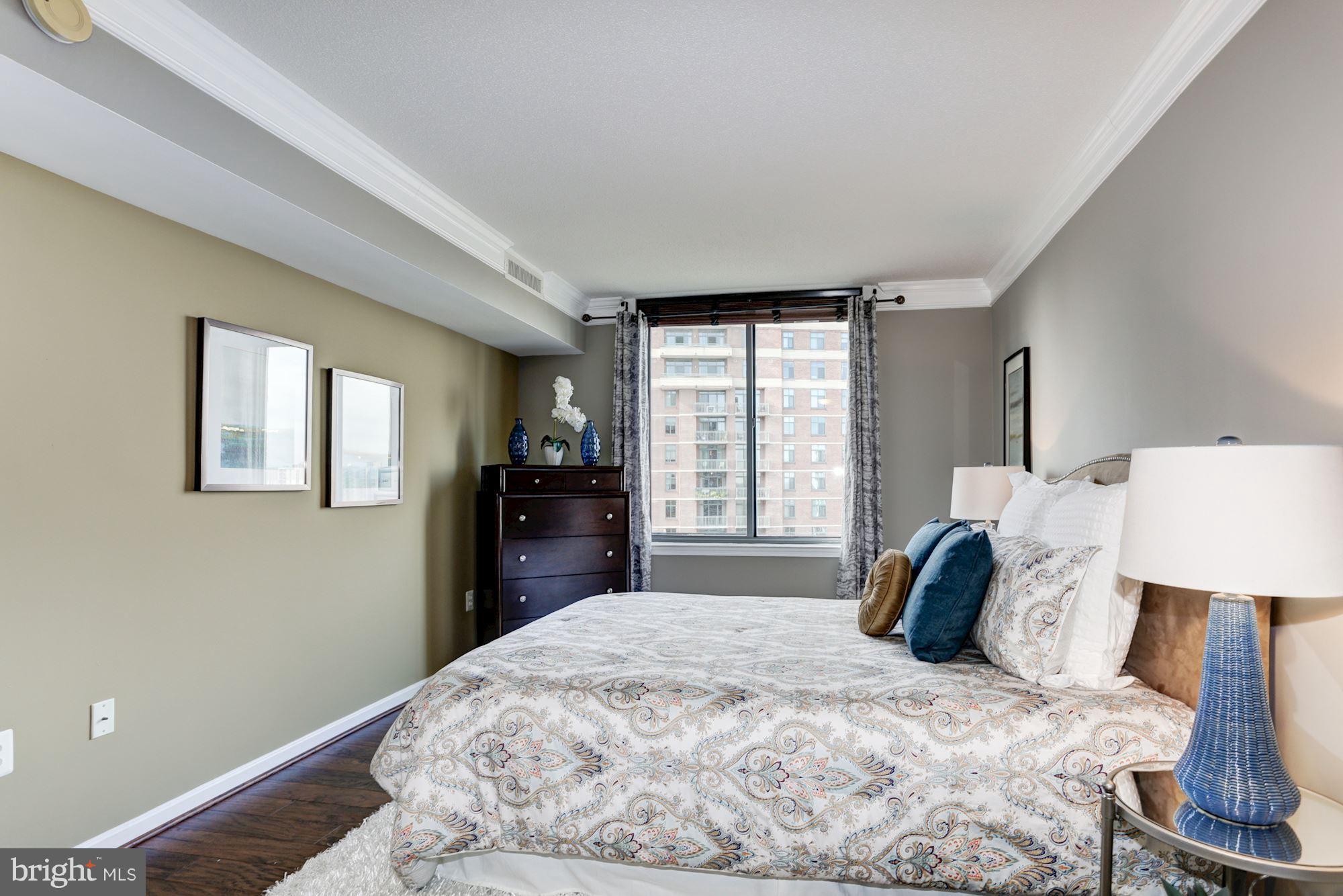11710 Old Georgetown Road, Unit 1127 North Bethesda, MD 20852 - Photo 14 of 30 a bedroom with a bed and wooden floor