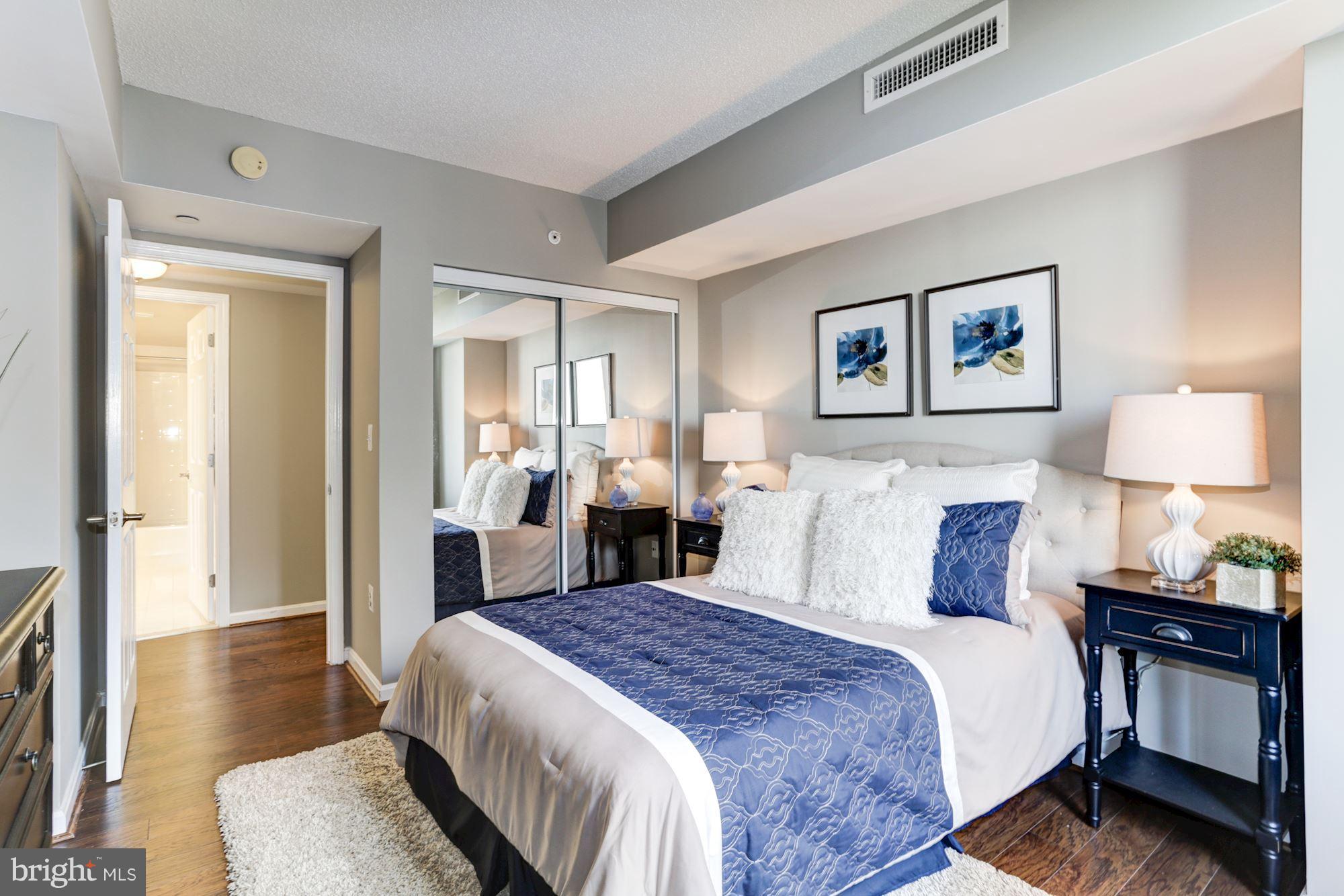 11710 Old Georgetown Road, Unit 1127 North Bethesda, MD 20852 - Photo 17 of 30 a bedroom with bed and wooden floor
