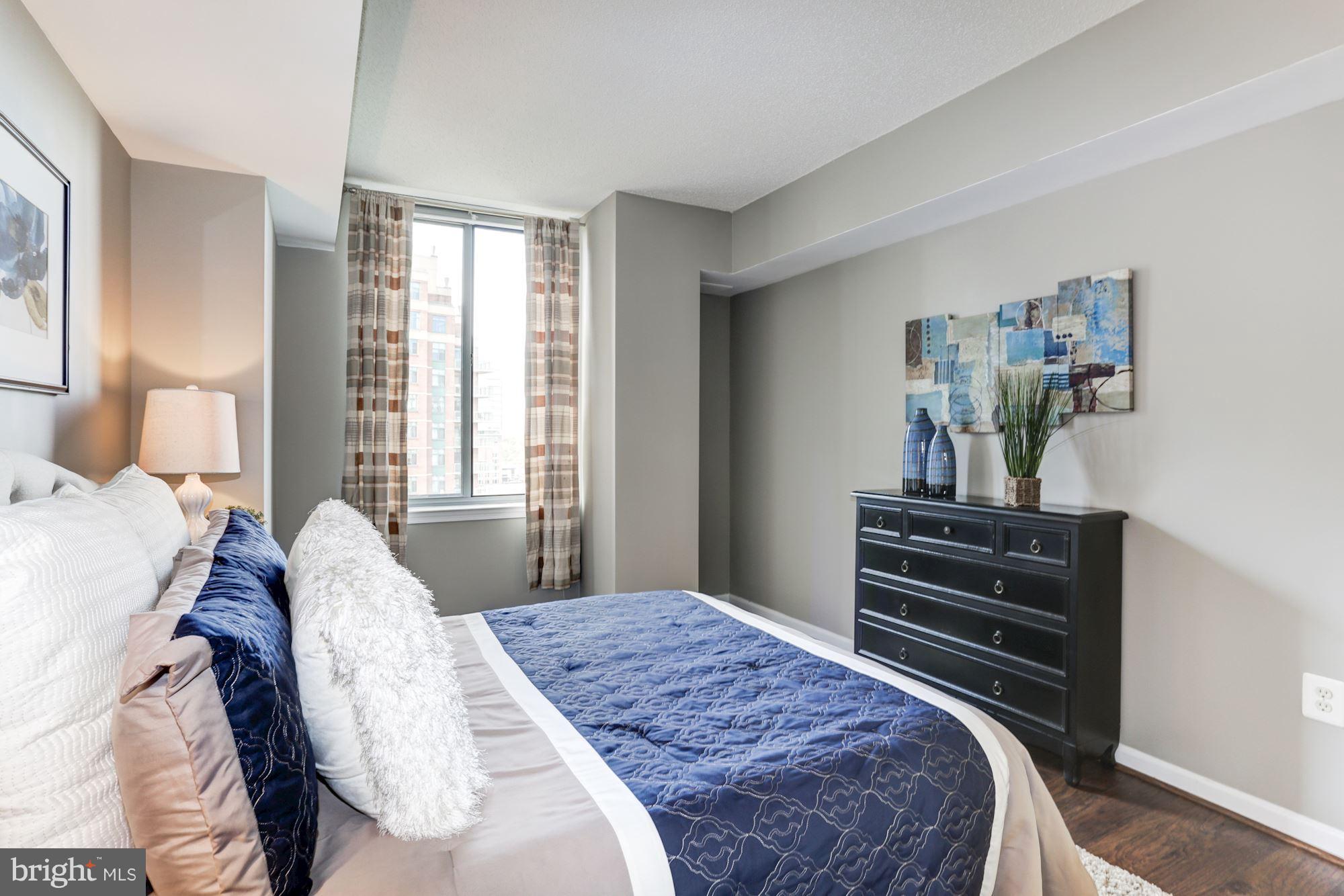 11710 Old Georgetown Road, Unit 1127 North Bethesda, MD 20852 - Photo 18 of 30 a bedroom with a bed and wooden floor
