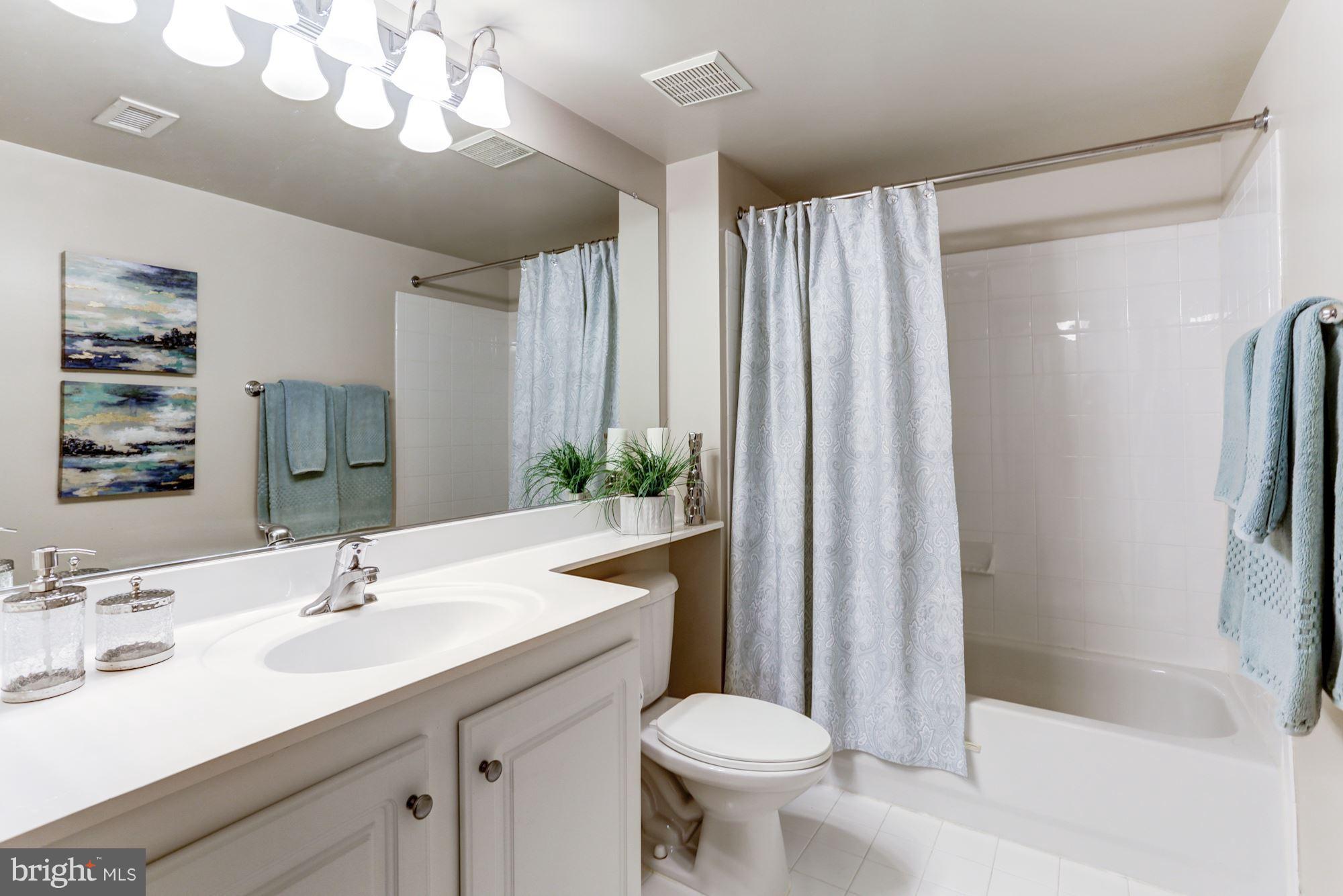 11710 Old Georgetown Road, Unit 1127 North Bethesda, MD 20852 - Photo 19 of 30 a bathroom with a sink a toilet and shower