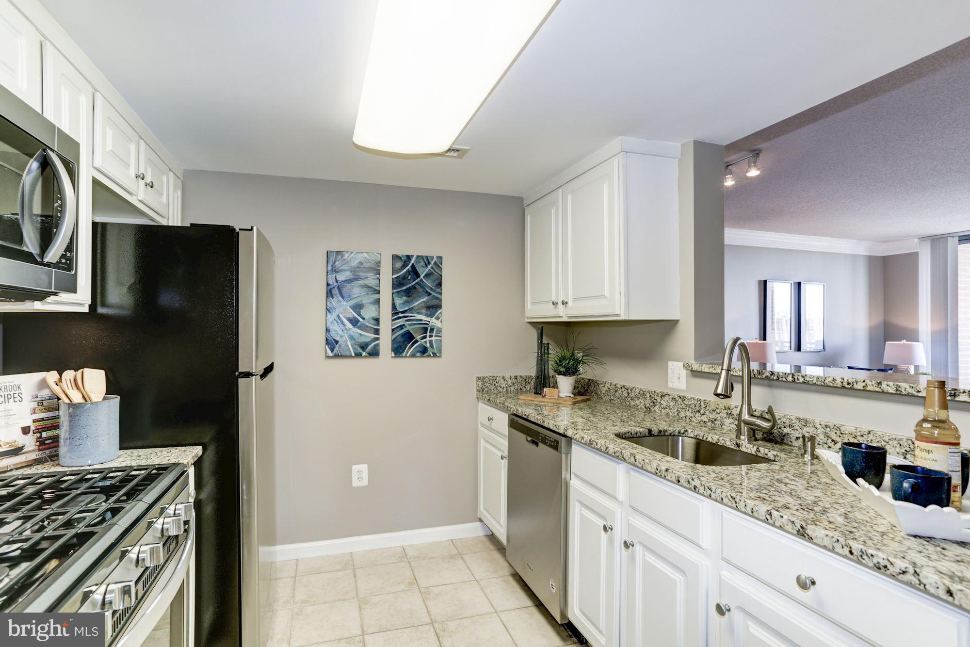 11710 Old Georgetown Road, Unit 1127 North Bethesda, MD 20852 - Photo 4 of 30 a kitchen with granite countertop a sink stove and refrigerator
