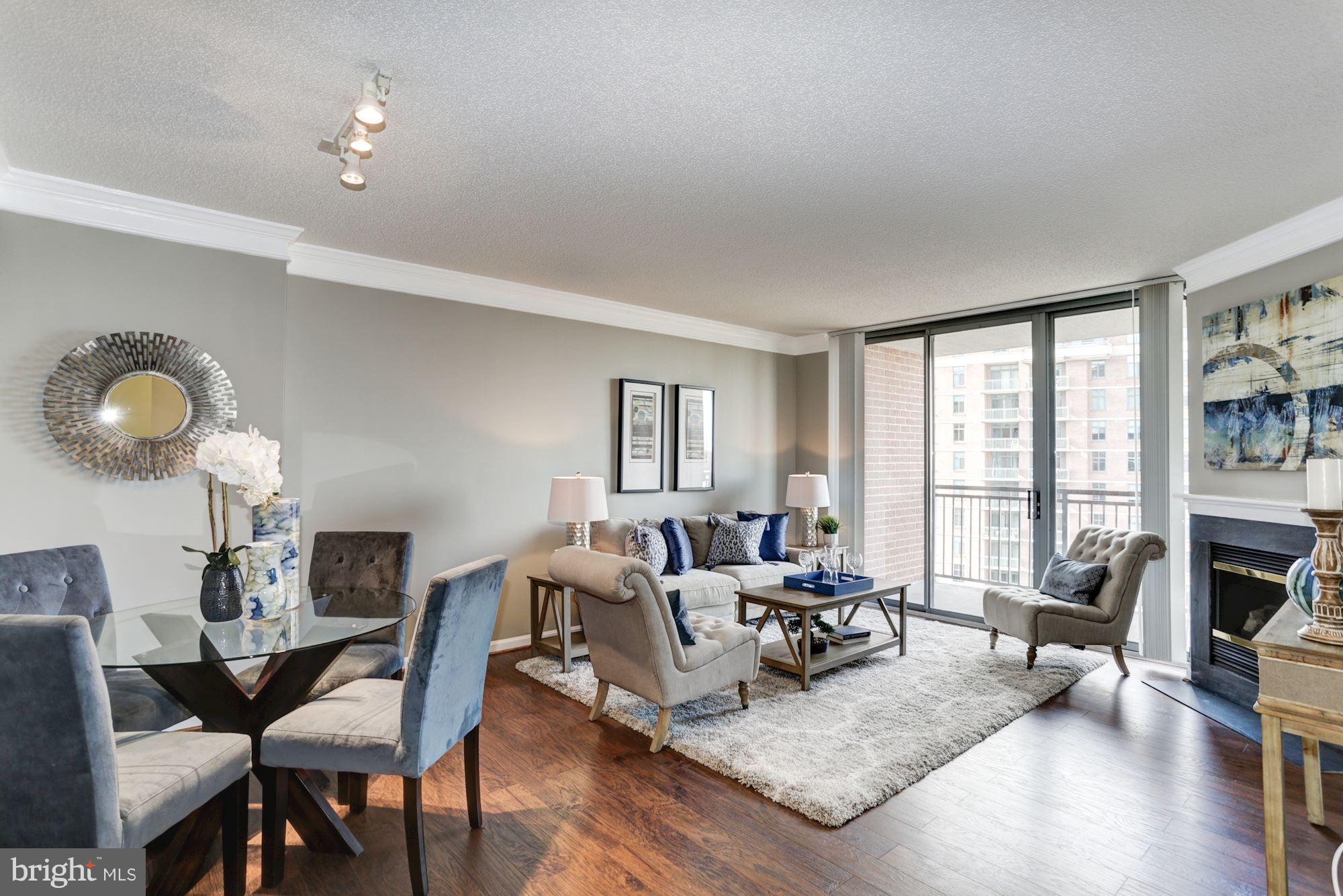 11710 Old Georgetown Road, Unit 1127 North Bethesda, MD 20852 - Photo 6 of 30 a living room with furniture fireplace and a large window