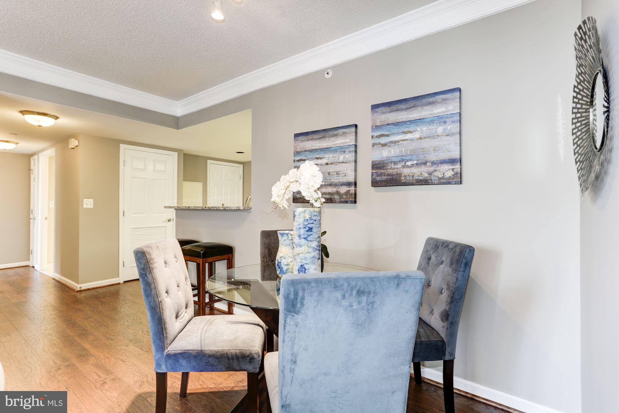 11710 Old Georgetown Road, Unit 1127 North Bethesda, MD 20852 - Photo 7 of 30 a dining room with furniture and wooden floor
