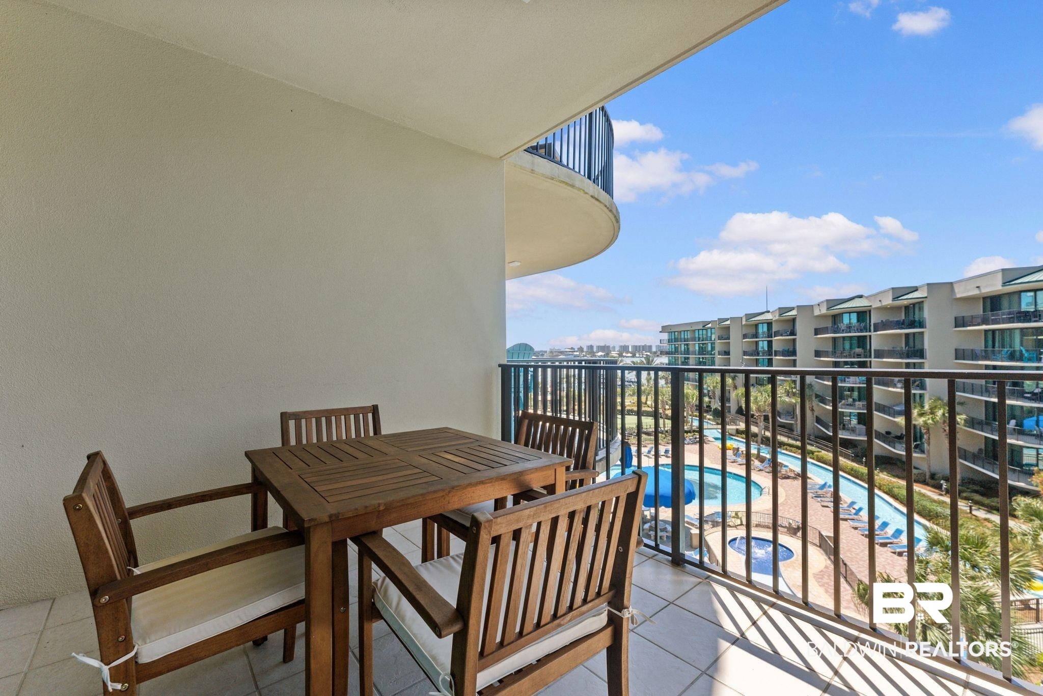27580 Canal Road, Unit 1427 Orange Beach, AL 36561 - Photo 32 of 38 Balcony featuring view of pool area and outdoor dining area