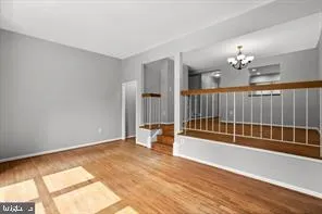 a view of a livingroom with wooden floor and a ceiling fan