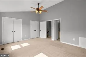 a view of a big room with chandelier fan and windows