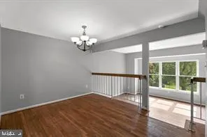 a view of a bedroom with wooden floor